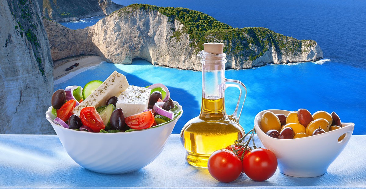 Famous Navagio beach with Greek salad in Zakynthos, Greece